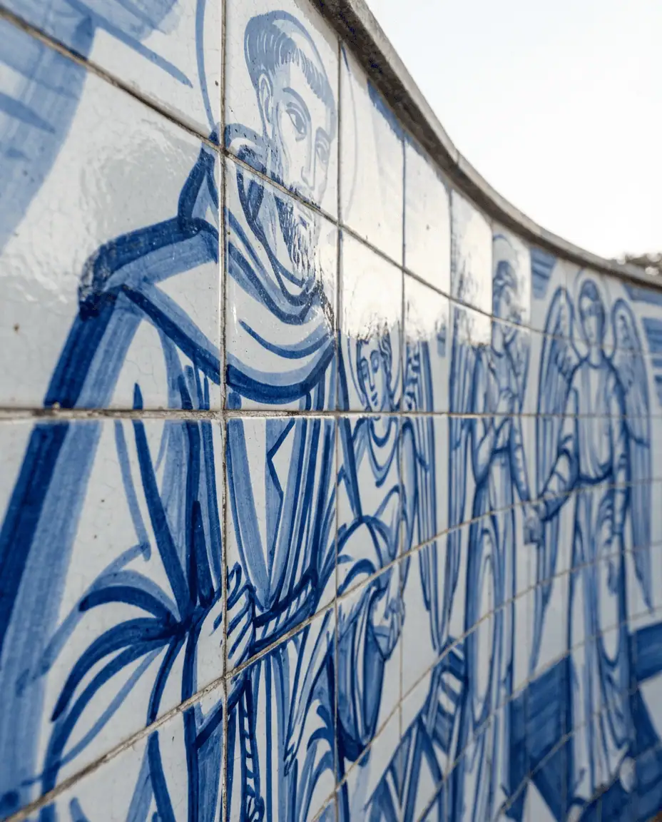 A close-up of the blue and white azulejo tile murals by Cândido Portinari on the exterior of the Saint Francis of Assisi Church, depicting bold, modernist religious scenes.